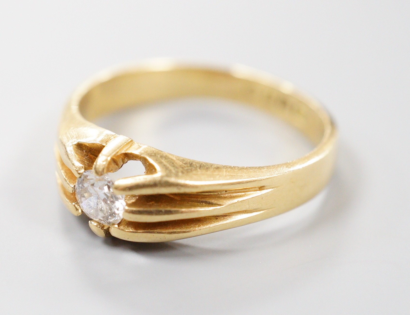 A late Victorian 18ct gold and claw set solitaire diamond ring, size, S/T, gross 6.3 grams.